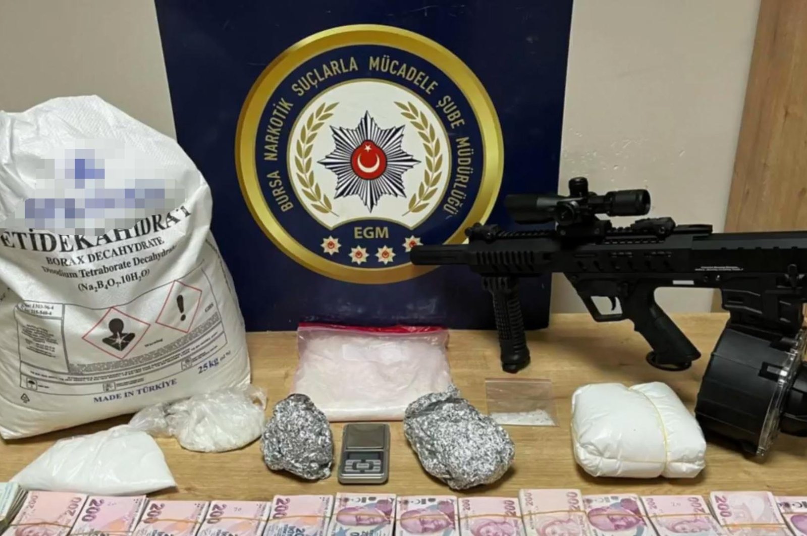 Police display drugs, cash, arms and other smuggled material seized during anti-narcotics operations across 41 provinces, Türkiye, Jan. 25, 2024. (DHA Photo)