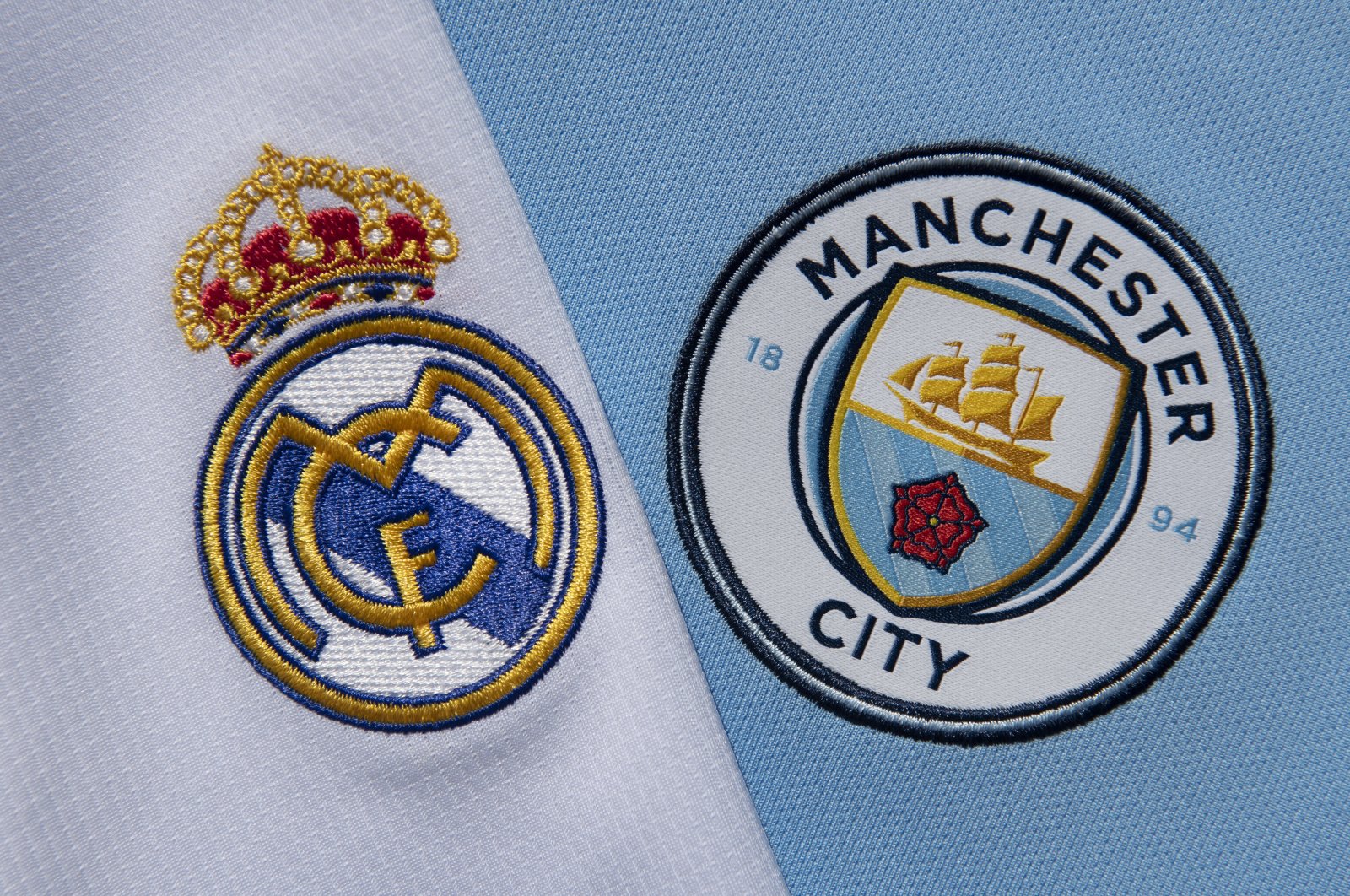 Real Madrid (L) and Manchester City club crests on their first team home shirts, Manchester, U.K., Sept. 1, 2020. (Getty Images Photo)