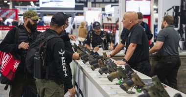 Visitors examine firearms produced by one of the Turkish leading manufacturers, Sarsılmaz, displayed during an expo held in Las Vegas, U.S., Jan. 26, 2024. (AA Photo)