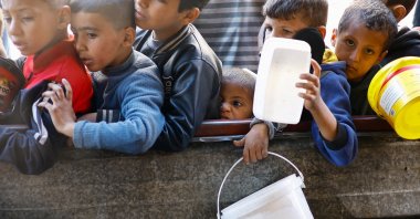 Palestinian children wait to receive food cooked by a charity kitchen amid shortages of food supplies, in Rafah in the southern Gaza Strip, Palestine, Jan. 16, 2024. (Reuters Photo)
