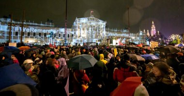 People take part in a rally under the motto "Defend Democracy" against right-wing extremism, racism and anti-Semitism as rain falls in front of the parliament in Vienna, Austria on Jan. 26, 2024. (AFP Photo)