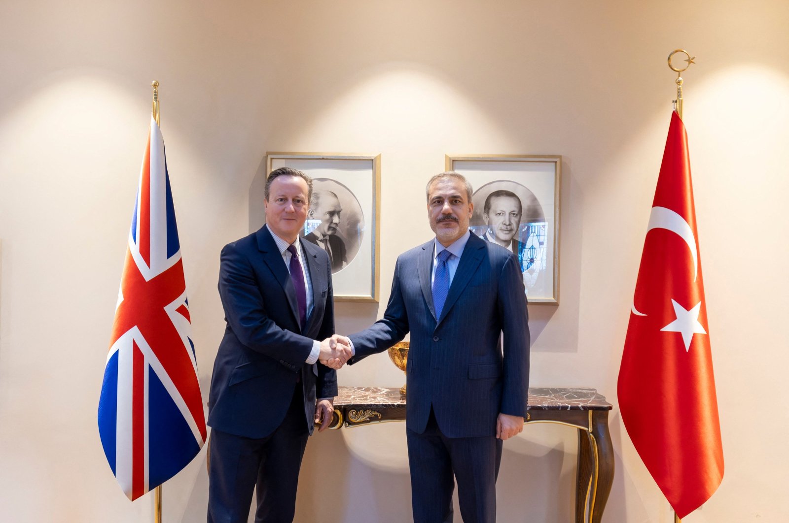 Foreign Minister Hakan Fidan (R) shakes hands with his counterpart UK Foreign Secretary David Cameron (L) during their meeting in Istanbul, Türkiye, on January 26, 2024. (AFP Photo) 