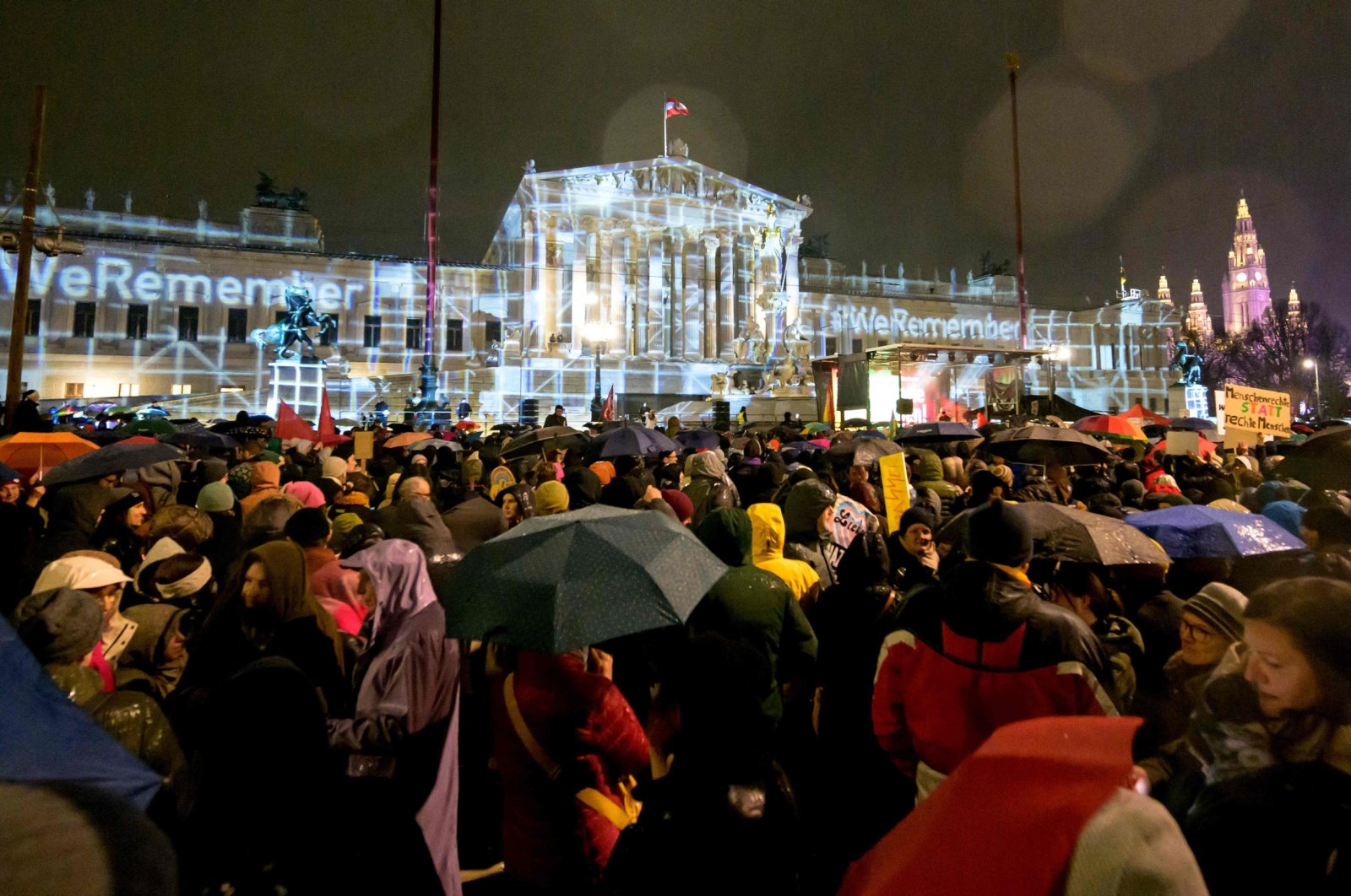 People take part in a rally under the motto &quot;Defend Democracy&quot; against right-wing extremism, racism and anti-Semitism as rain falls in front of the parliament in Vienna, Austria on Jan. 26, 2024. (AFP Photo)