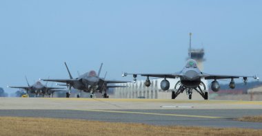 U.S. Air Force F-16 Fighting Falcon (R) and F-35A Lightning II fighter jets taxiing at Kunsan Air Base in the southwestern port city of Gunsan, South Korea. (Photo by U.S. Air Force via AFP)