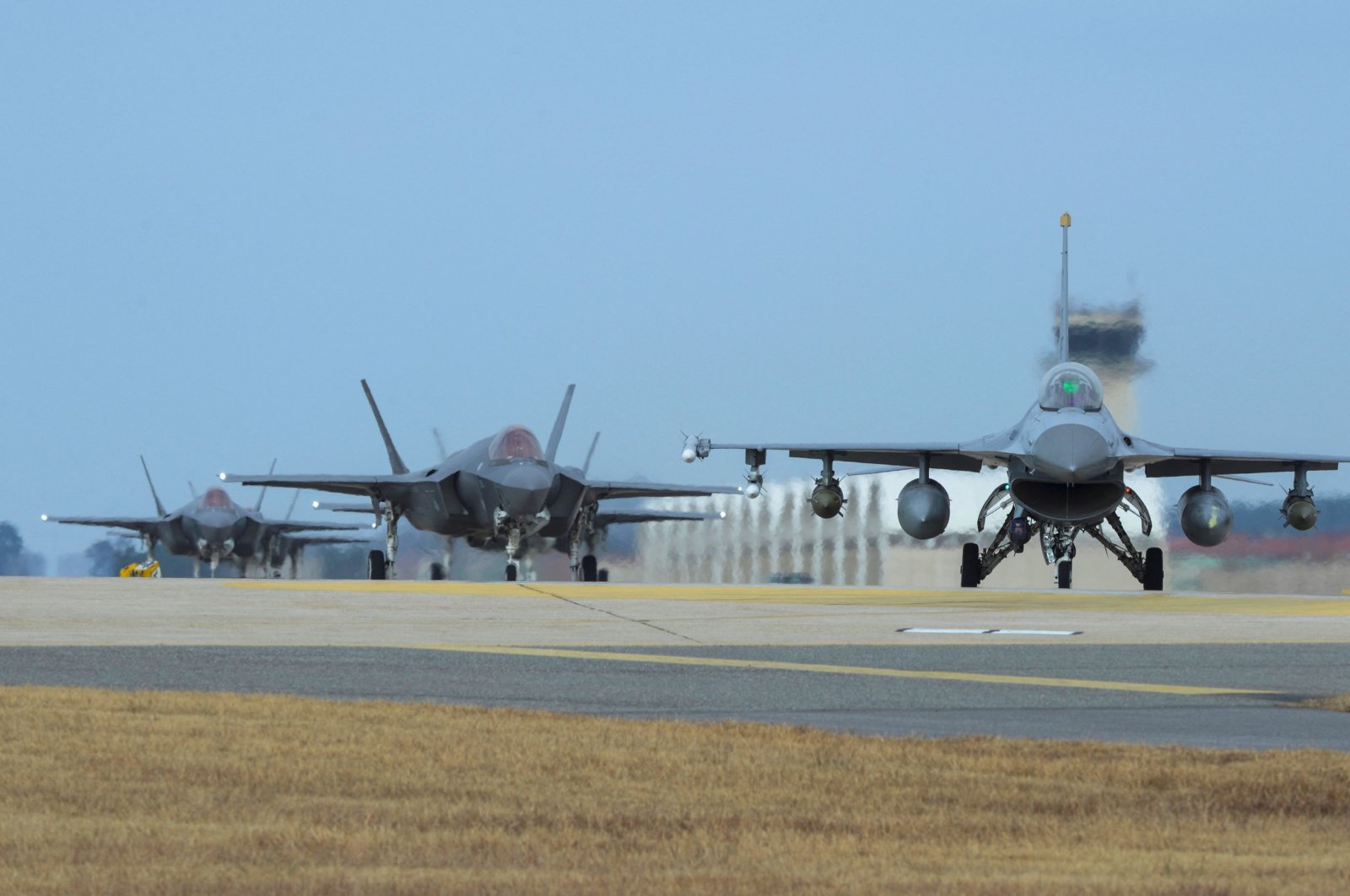 U.S. Air Force F-16 Fighting Falcon (R) and F-35A Lightning II fighter jets taxiing at Kunsan Air Base in the southwestern port city of Gunsan, South Korea. (Photo by U.S. Air Force via AFP)