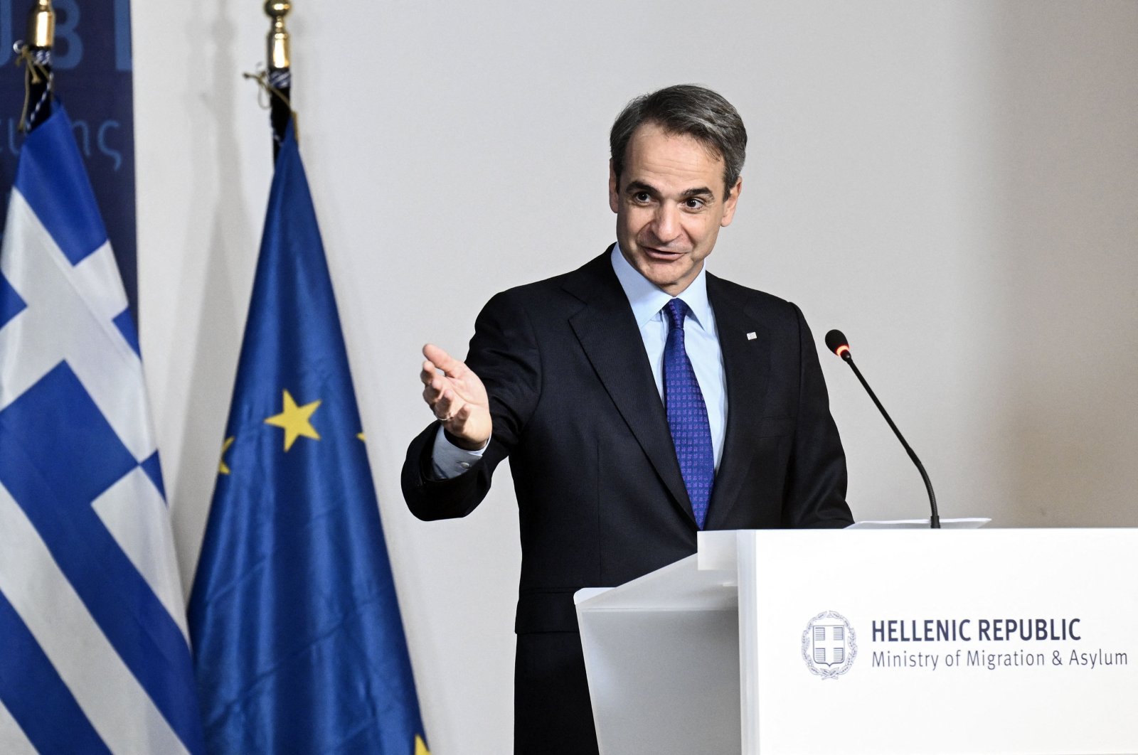 Greek Prime Minister Kyriakos Mitsotakis gestures as he talks at a lectern during a panel discussing the details of a preliminary EU agreement on migration management at the Ministry of Migration and Asylum in Athens, on Jan. 8, 2024. (AFP Photo)