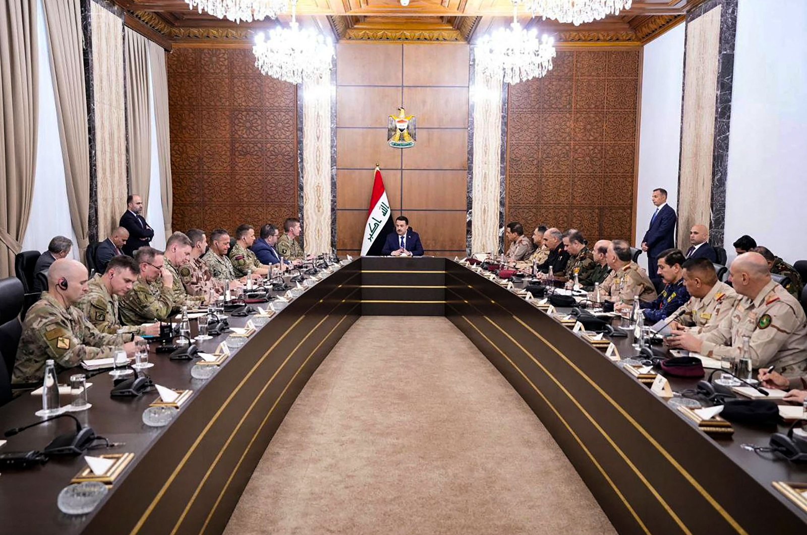 A handout picture released by Iraq&#039;s Prime Minister&#039;s Media Office on Jan. 27, 2024, shows Prime Minister Mohamed Shia al-Sudani (C) meeting with top-ranking officials of the Iraqi armed forces (R) and the international coalition set up by U.S., In Baghdad. (AFP Photo)