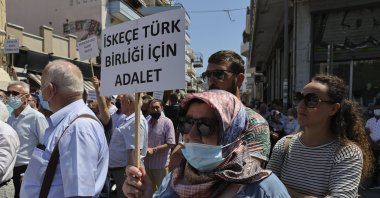 A Turkish Greek woman holds up a sign that reads "Justice for Turkish community of Iskeçe (Xanthi)" during a protest against the Greek Supreme Court's rejection of the community's reregistration in contravention of European Court of Human Rights (ECtHR) rulings, Western Thrace, Greece, July 12, 2021. (AA Photo)