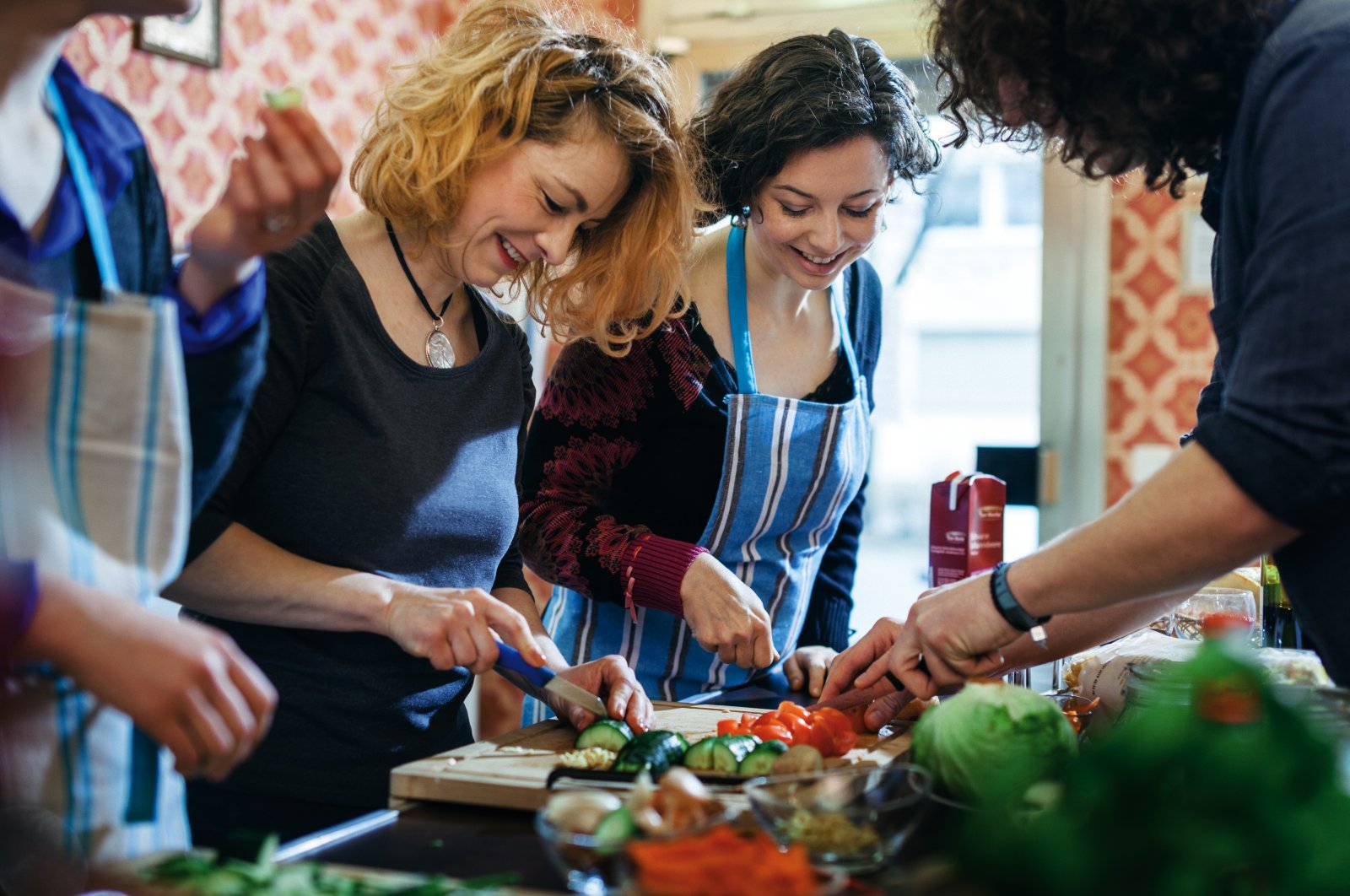 Participants of a cooking class enjoy cutting vegetables. (Getty Images Photo)