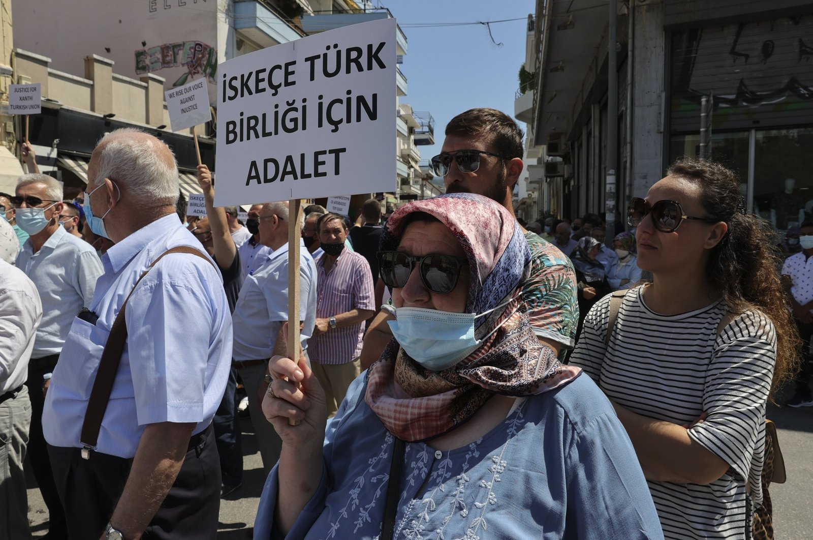 A Turkish Greek woman holds up a sign that reads "Justice for Turkish community of Iskeçe (Xanthi)" during a protest against the Greek Supreme Court&#039;s rejection of the community&#039;s reregistration in contravention of European Court of Human Rights (ECtHR) rulings, Western Thrace, Greece, July 12, 2021. (AA Photo)