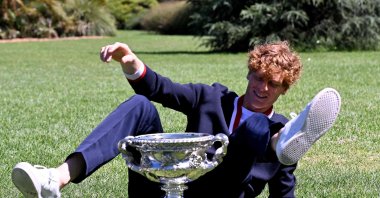 Italy&#039;s Jannik Sinner poses with the Norman Brookes Challenge Cup trophy at the Royal Botanic Gardens following his victory against Russia&#039;s Daniil Medvedev in the men&#039;s singles final of the Australian Open, Melbourne, Australia, Jan. 29, 2024. (AFP Photo)