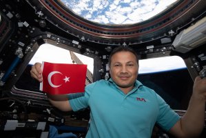 Turkish astronaut Alper Gezeravcı holding Türkiye's flag, the International Space Station (ISS), Space, Jan. 26, 2024. (AA Photo)
