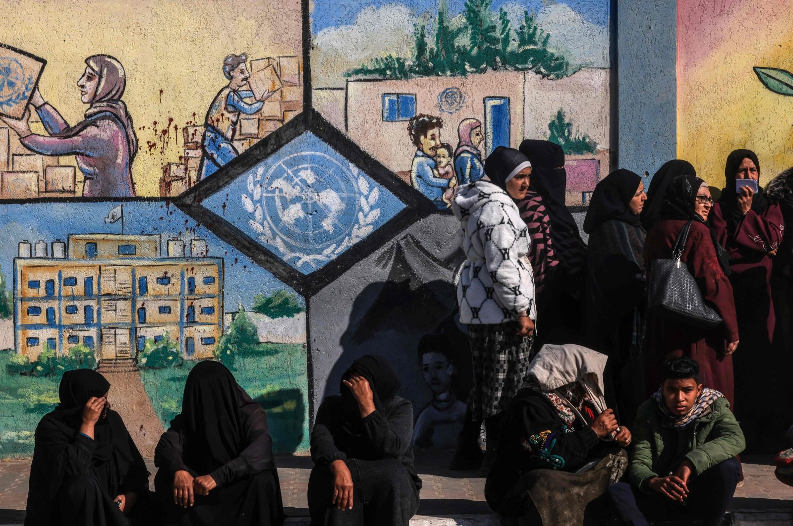 Displaced Palestinians wait to receive aid in front of the United Nations Relief and Works Agency for Palestine Refugees (UNRWA) center in Rafah in the southern Gaza Strip, Palestine, Jan. 28, 2024. (AFP Photo)