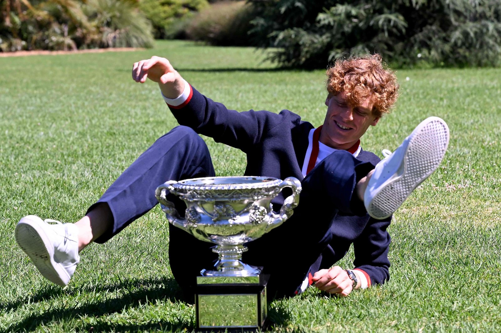 Italy&#039;s Jannik Sinner poses with the Norman Brookes Challenge Cup trophy at the Royal Botanic Gardens following his victory against Russia&#039;s Daniil Medvedev in the men&#039;s singles final of the Australian Open, Melbourne, Australia, Jan. 29, 2024. (AFP Photo)