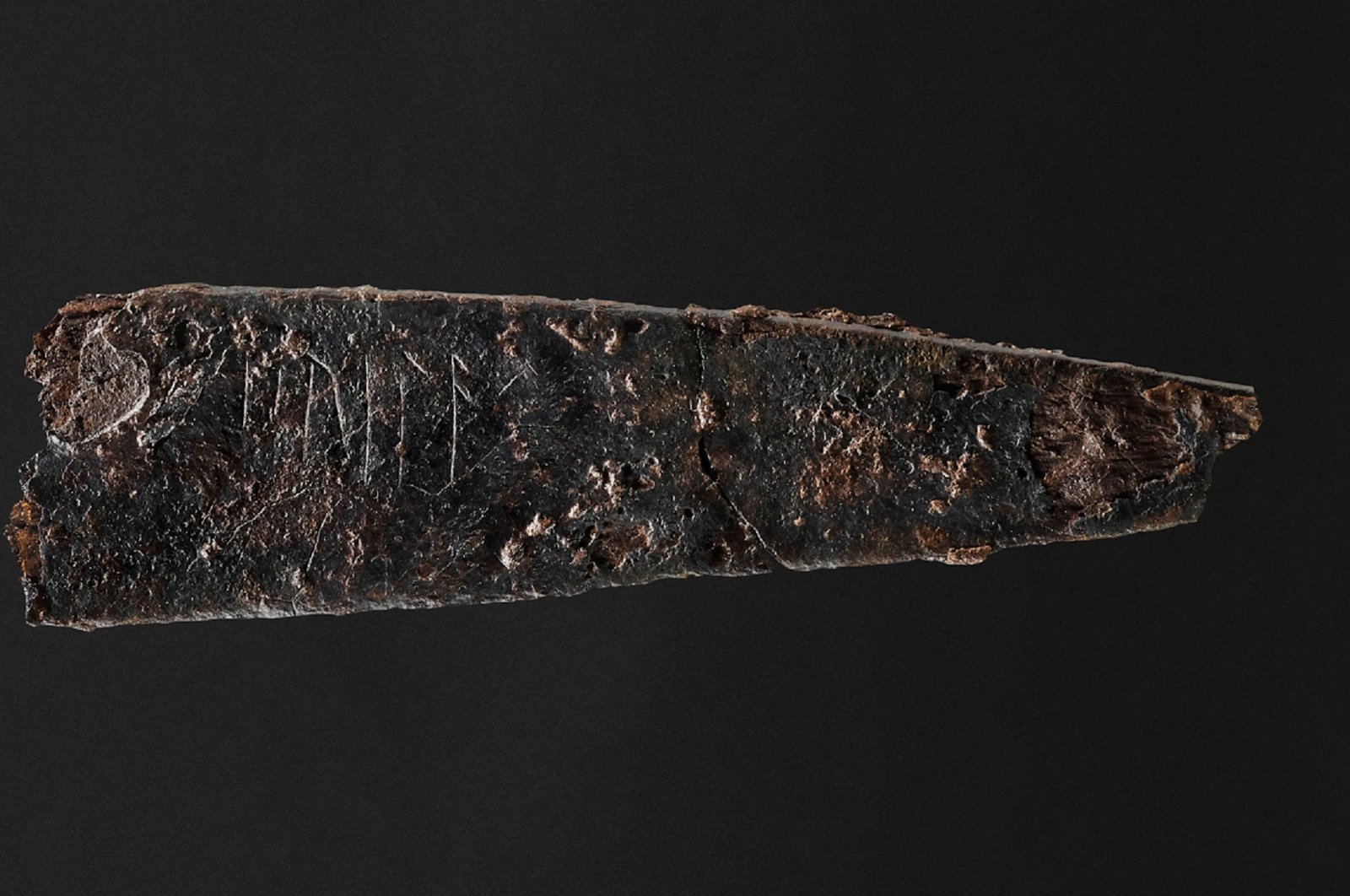 An undated handout photo from the Museum Odense in Denmark shows a small knife inscribed with runes dating back nearly 2,000 years, the oldest writing found in the country. (AFP Photo)