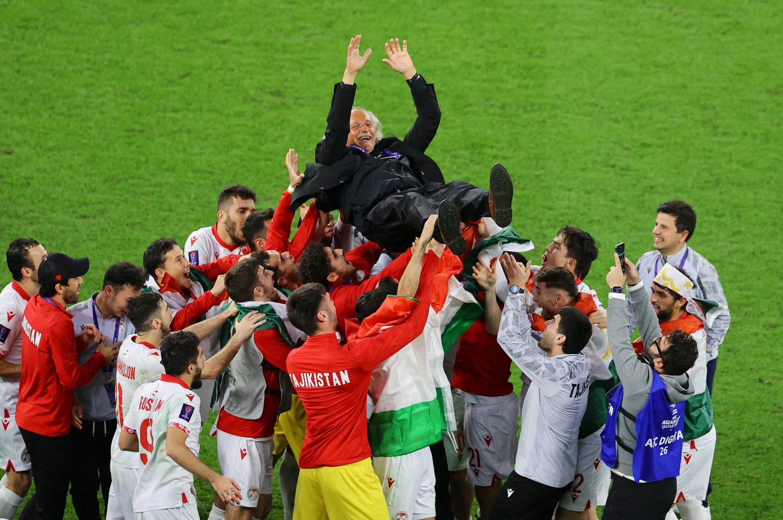 Tajikistan players celebrate with coach Petar Segrt after the match against the United Arab Emirates at the Ahmad bin Ali Stadium, Al Rayyan, Qatar, Jan. 28, 2024. (Reuters Photo)