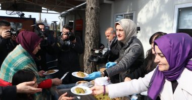 Türkiye's Women and Democracy Foundation (KADEM) Chairperson Saliha Okur Gümrükçüoğlu (R) serves a sweet dish for earthquake victims in a container city, Kahramanmaraş, Türkiye, Jan. 30, 2024. (AA Photo)