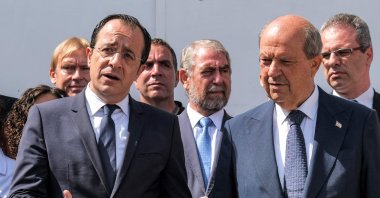Turkish Cypriot President Ersin Tatar (R) and Greek Cypriot administration head Nikos Christodoulides (L) speak to reporters outside the anthropological laboratory of the Committee on Missing Persons in Cyprus (CMP) in the U.N. buffer zone splitting the divided capital Lefkoşa (Nicosia), TRNC, July 28, 2023. (AFP Photo)