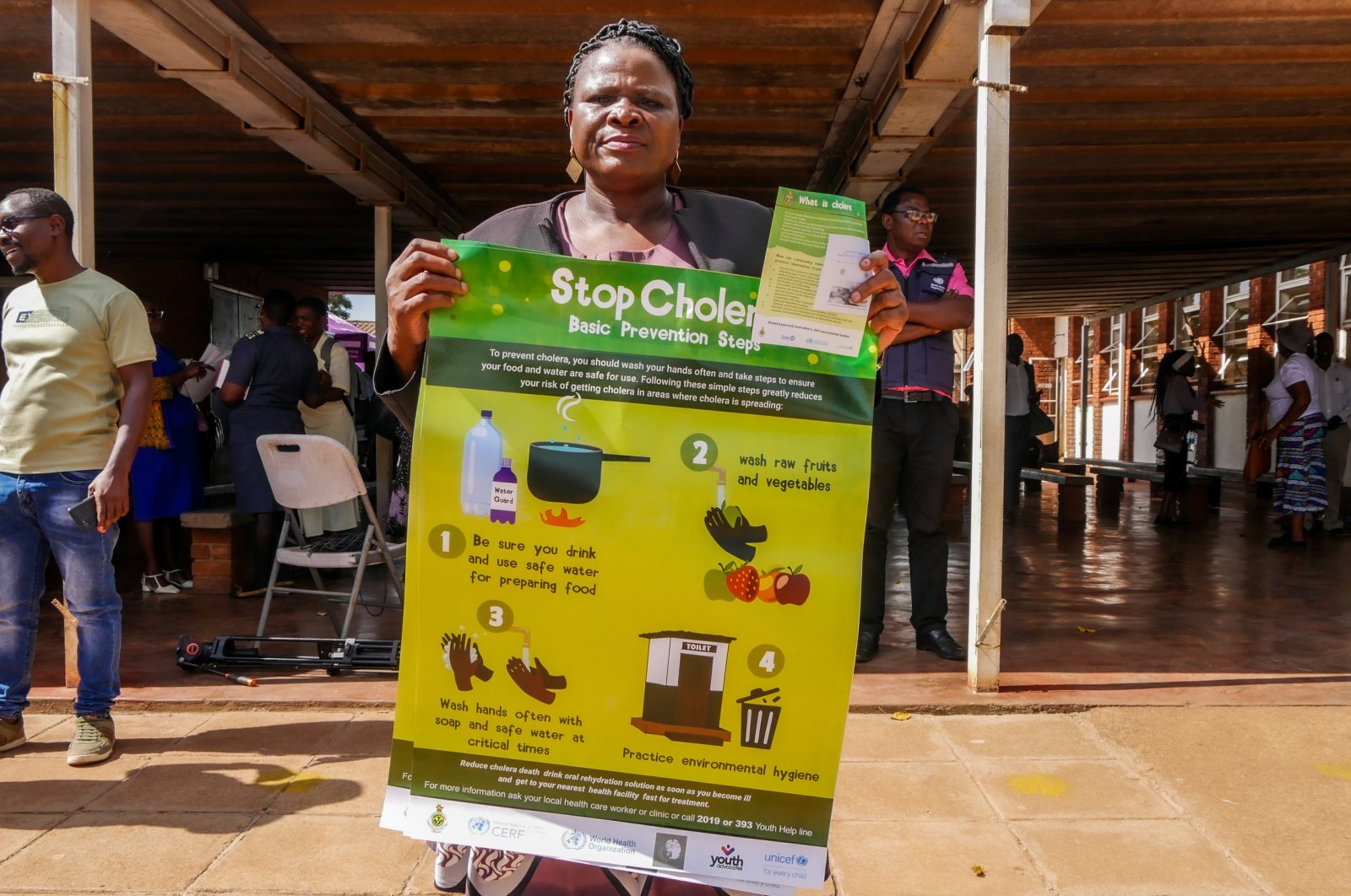 A woman displays a poster informing against cholera during the launch of a cholera vaccination program at the Kuwadzana Polyclinic, Harare, Zimbabwe, Jan. 29, 2024. (EPA Photo)