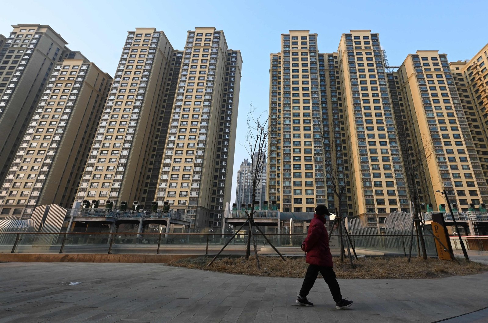 A woman walks past an Evergrande Group residential complex called Evergrande Palace in Beijing, China, Jan. 29, 2024. (AFP Photo)