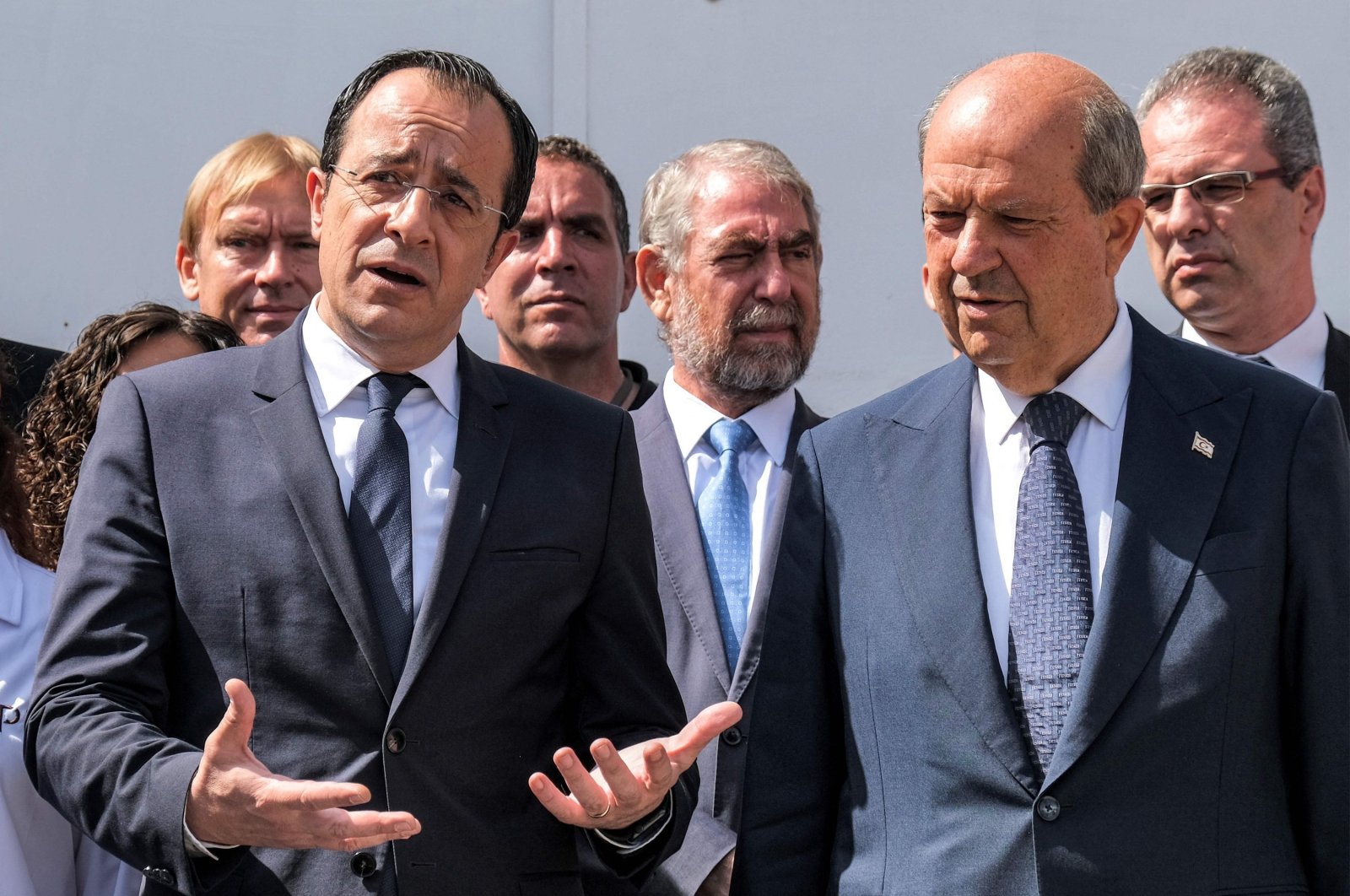 Turkish Cypriot President Ersin Tatar (R) and Greek Cypriot administration head Nikos Christodoulides (L) speak to reporters outside the anthropological laboratory of the Committee on Missing Persons in Cyprus (CMP) in the U.N. buffer zone splitting the divided capital Lefkoşa (Nicosia), TRNC, July 28, 2023. (AFP Photo)