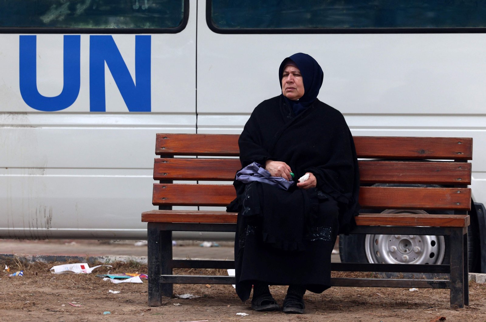 A displaced Palestinian woman sits on a bench outside a UNRWA clinic in Rafah, southern Gaza Strip, Palestine, Jan. 28, 2024. (AFP Photo)