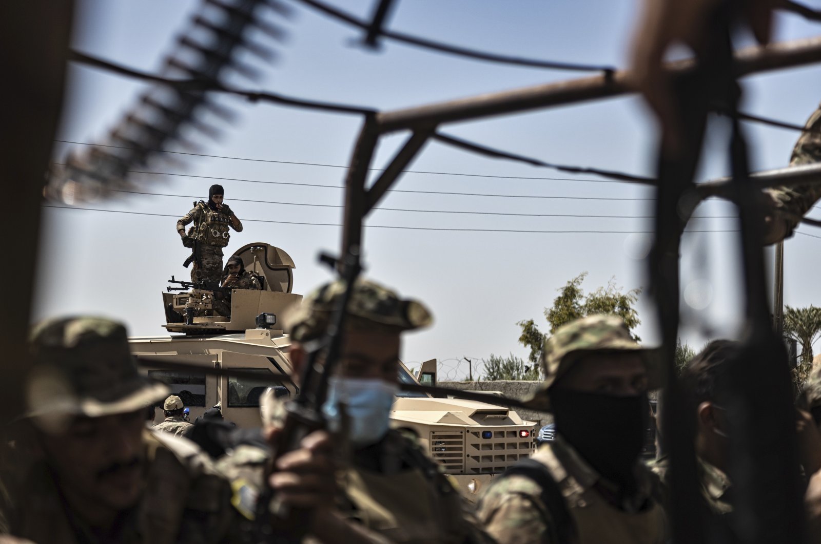 U.S.-backed PKK/YPG terrorists sit on their armored vehicles, in the town of al-Sabha in the eastern countryside of Deir el-Zour, Syria, Sept. 4, 2023. (AP Photo)
