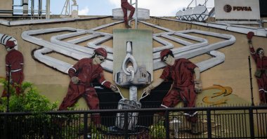 A mural at the PDVSA headquarters shows men working at oil refineries, Caracas, Venezuela, Sept. 13, 2023. (AFP Photo)