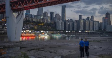Security officers stand on a hillside, Chongqing, southwestern China, Aug. 20, 2022. (AP Photo)
