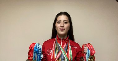 Turkish arm wrestler Sultan Sivrihisarlı poses for a photo with her medals, Afyon, Türkiye, Jan. 31, 2024. (AA Photo)