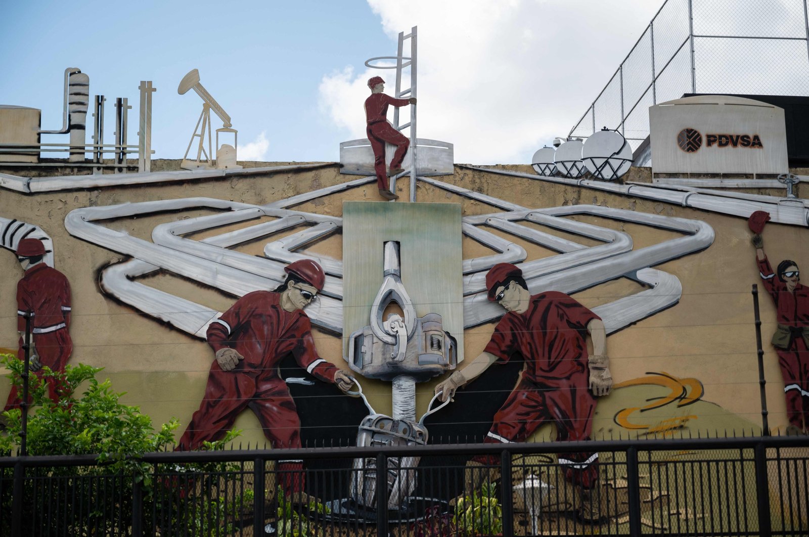 A mural at the PDVSA headquarters shows men working at oil refineries, Caracas, Venezuela, Sept. 13, 2023. (AFP Photo)