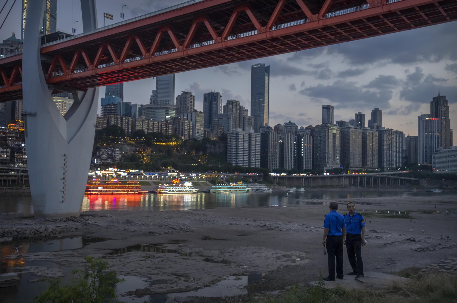 Security officers stand on a hillside, Chongqing, southwestern China, Aug. 20, 2022. (AP Photo)