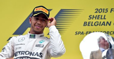 Mercedes AMG Petronas F1 Team&#039;s British driver Lewis Hamilton looks at the trophy as he celebrates winning on the podium at the Spa-Francorchamps circuit after the Belgian Formula One Grand Prix, in Spa, Belgium, Aug. 23, 2015. (AFP File Photo)