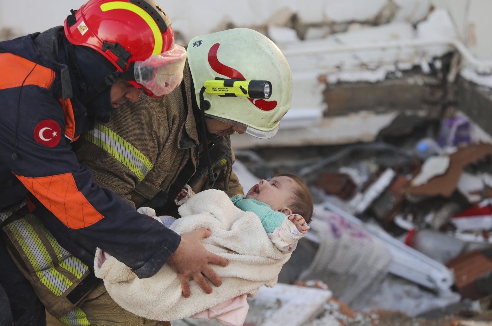 Six-month-old baby Ayşe Vera Yılmaz is rescued alive from the wreckage of a building, 29 hours after it collapsed during the earthquakes, in the Odabaşı neighborhood of Hatay, southern Türkiye, Feb. 6, 2023. (AA Photo)