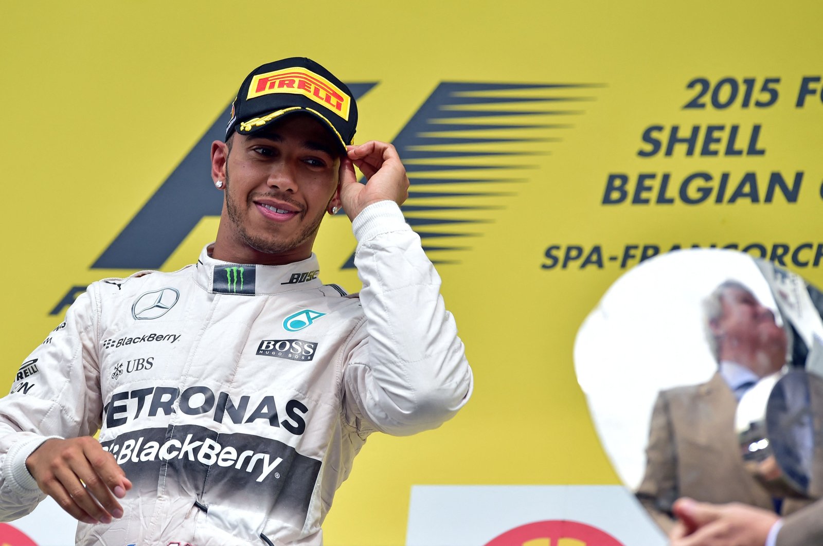 Mercedes AMG Petronas F1 Team&#039;s British driver Lewis Hamilton looks at the trophy as he celebrates winning on the podium at the Spa-Francorchamps circuit after the Belgian Formula One Grand Prix, in Spa, Belgium, Aug. 23, 2015. (AFP File Photo)