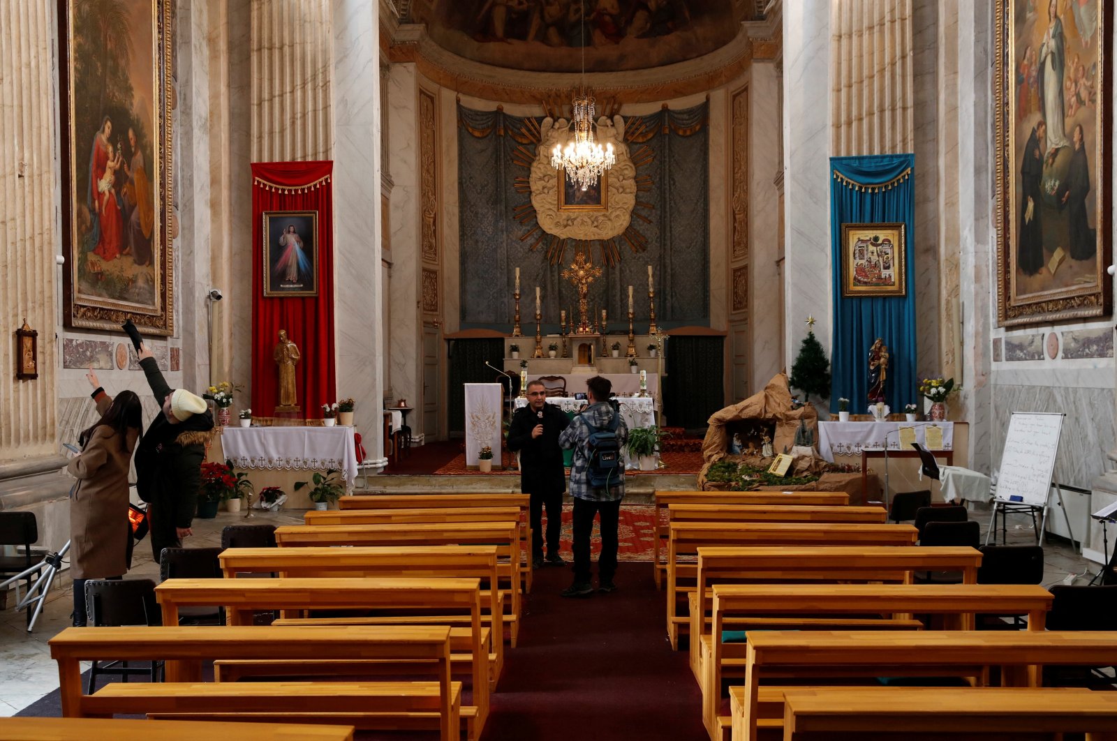 Media members visit the Italian Santa Maria Catholic Church a day after an attack killing one during the Sunday service, in Istanbul, Türkiye, Jan. 29, 2024. (Reuters Photo)