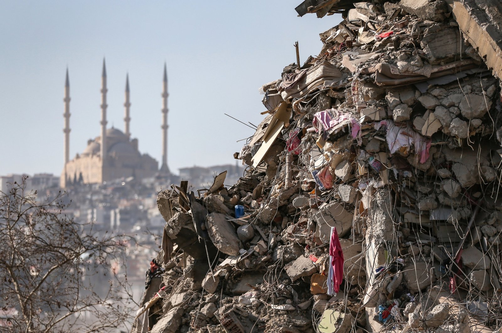 A collapsed building with Abdulhamid Han Mosque in the background after a powerful earthquake in Kahramanmaraş, Türkiye, Feb. 18, 2023. (EPA Photo)