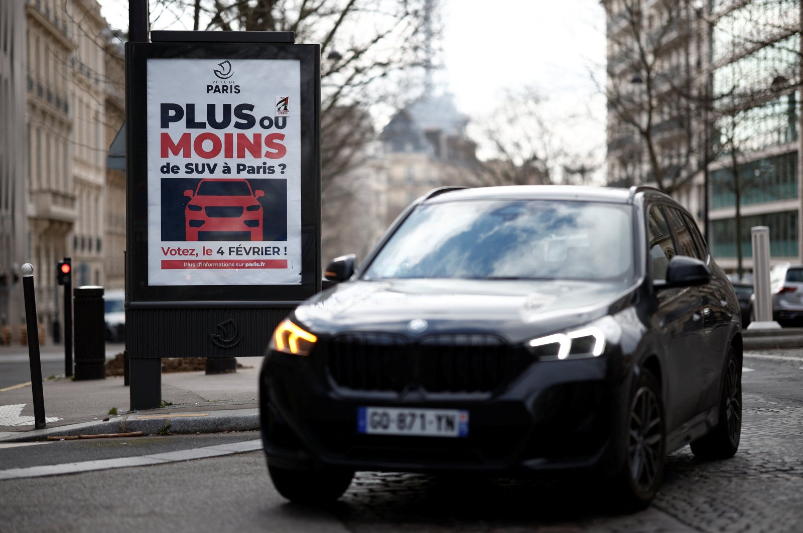 A poster reading &quot;More or less SUVs in Paris? Vote on February 4&quot; is seen on a billboard in a street as Paris City Hall is set to organize a public vote on SUVs in the city, Paris, France, Feb. 2, 2024. (Reuters Photo)