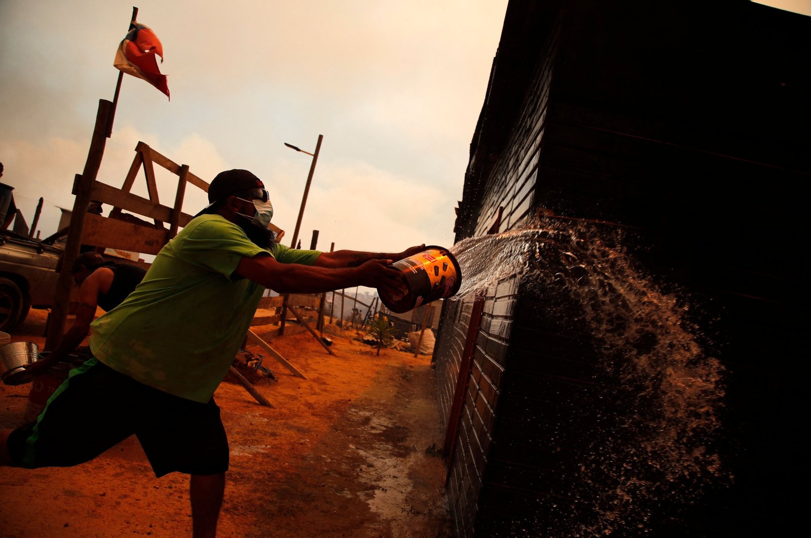 A man douses a forest fire in the hills in Quilpe comune, Valparaiso region, Chile, Feb. 3, 2024. (AFP Photo)