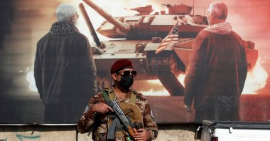 A paramilitary of the Hashd al-Shaabi (Popular Mobilization) forces stands guard during the funeral of a comrade, who died in American airstrikes, Baghdad, Iraq, Jan. 25, 2024. (AFP Photo)