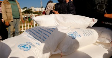 Palestinians receive flour bags distributed by UNRWA in Rafah, in the southern Gaza Strip Nov. 21, 2023. (Reuters File Photo)
