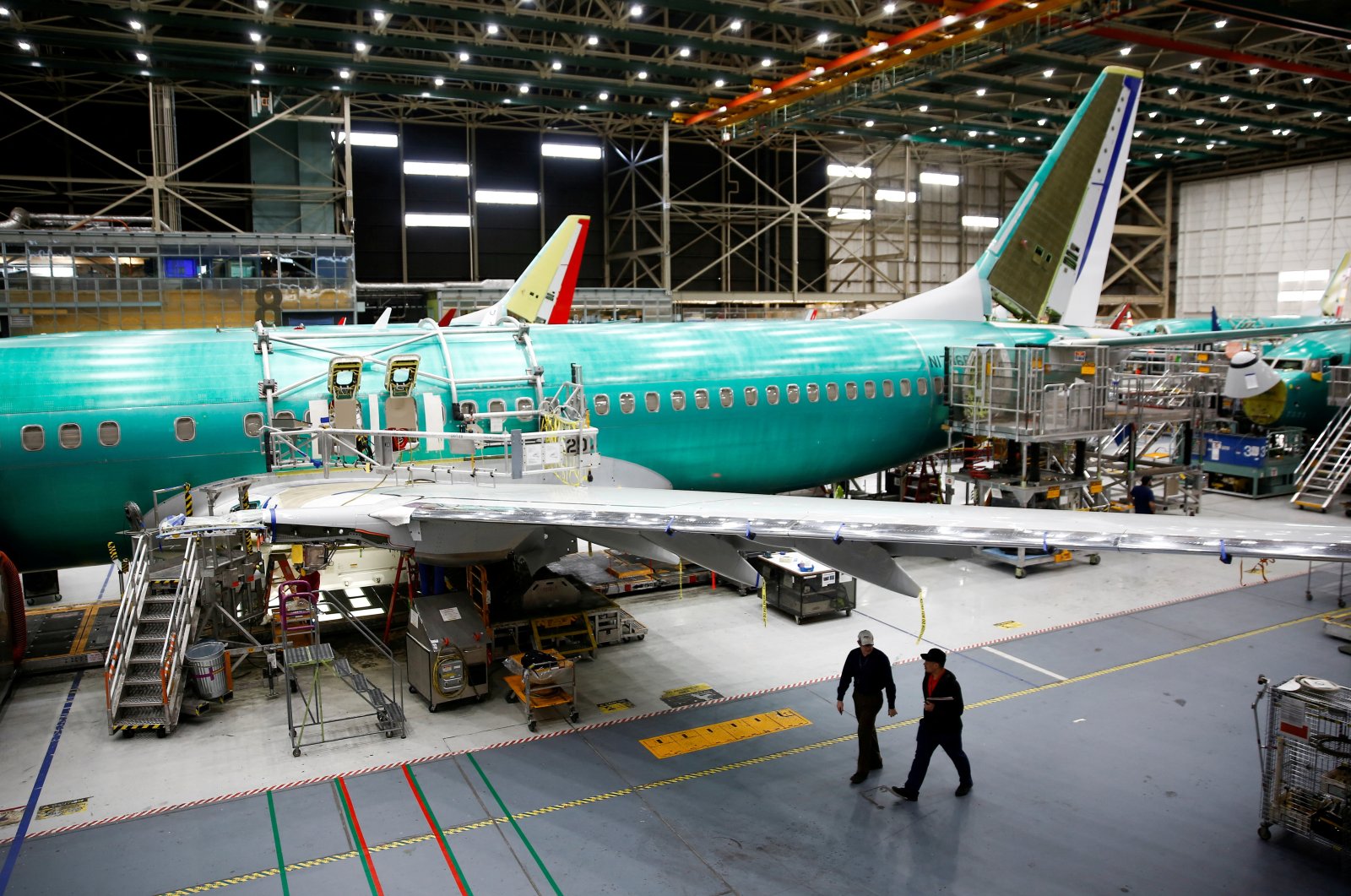 Two workers walk under the wing of a 737 Max aircraft at the Boeing factory in Renton, Washington, U.S., March 27, 2019. (Reuters Photo)