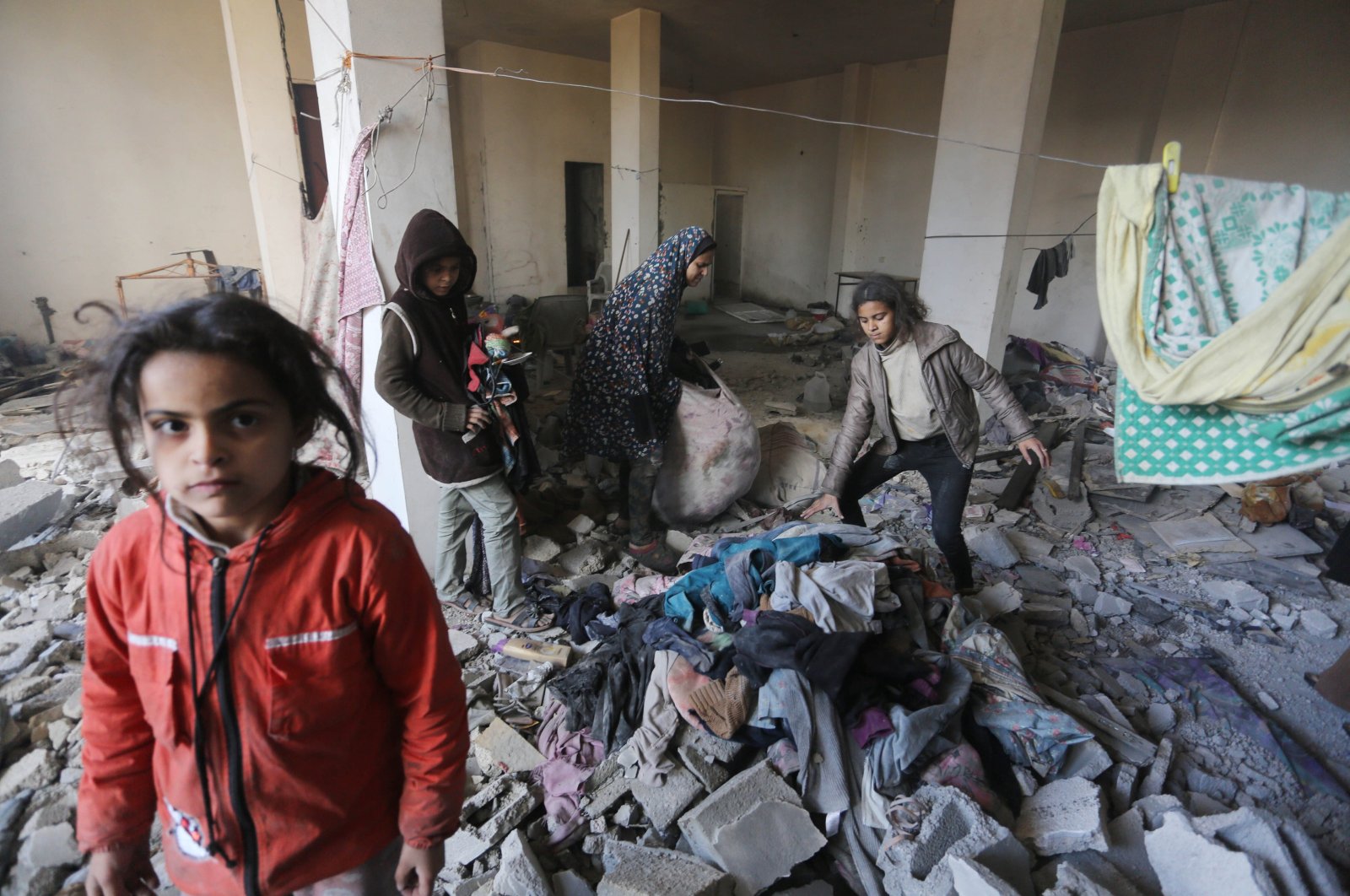 Palestinian children rummage through the rubbles of their home in Deir Al-Balah, Gaza, Palestine, Feb. 5, 2024. (AA Photo)