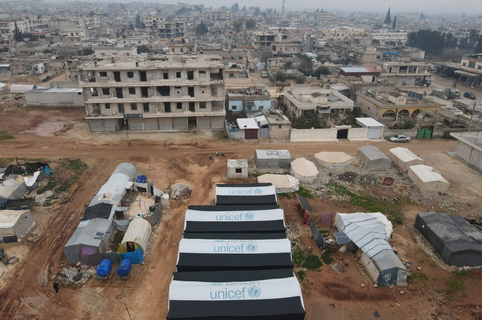 An aerial view shows U.N. children&#039;s agency UNICEF tents in the foreground for the displaced in the town of Jindayris northwest of Aleppo province on Feb.1, 2024. (AFP Photo)