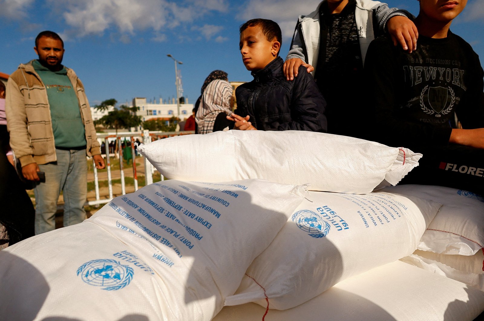 Palestinians receive flour bags distributed by UNRWA in Rafah, in the southern Gaza Strip Nov. 21, 2023. (Reuters File Photo)