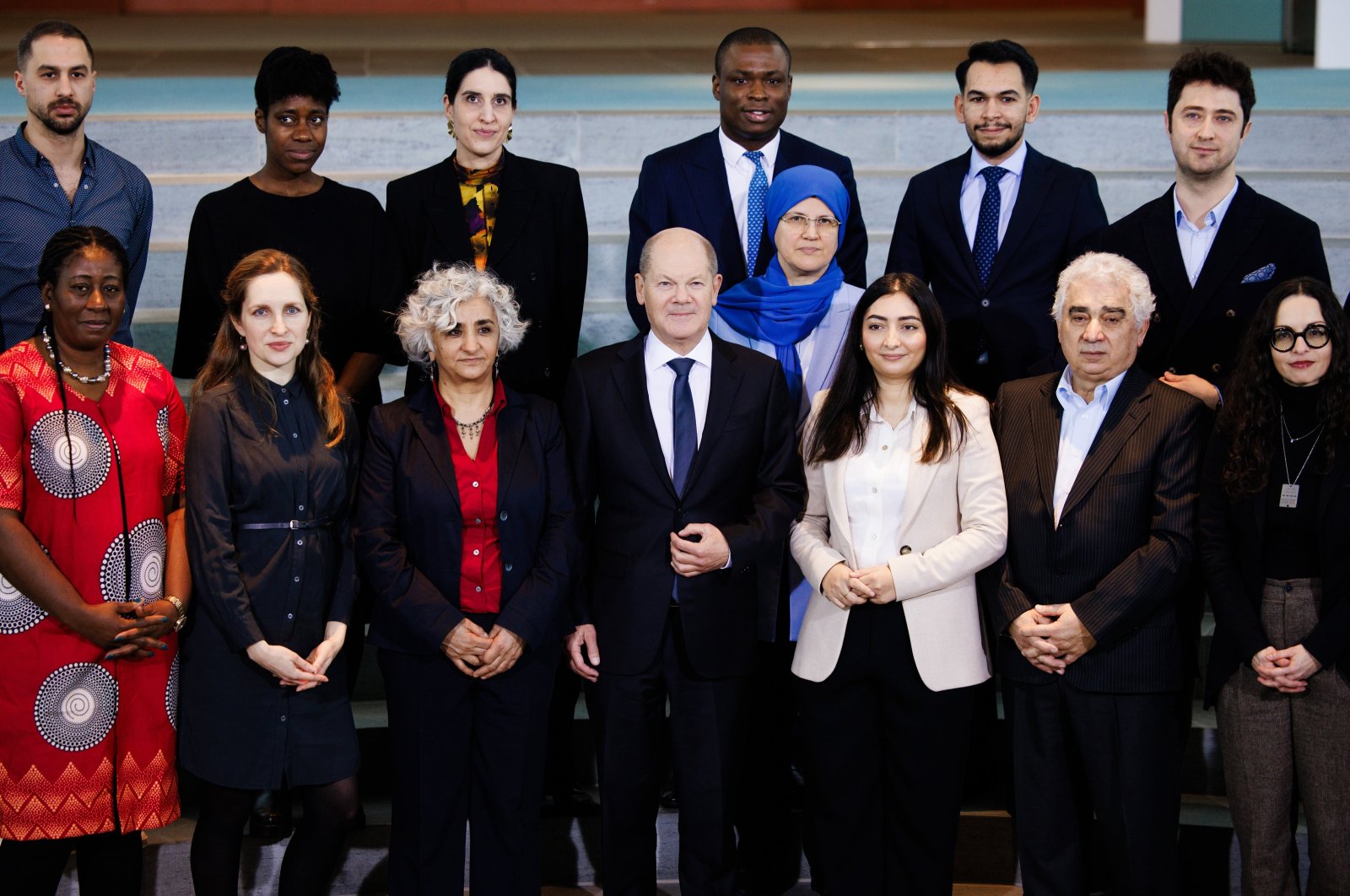 German Chancellor Olaf Scholz (Center) and Minister of State to the Federal Chancellor and Federal Government Commissioner for Migration, Refugees and Integration Reem Alabali-Radovan (C-R) pose with representatives of migrant organizations for media at the Chancellery in Berlin, Germany, Feb. 5, 2024. (EPA Photo)