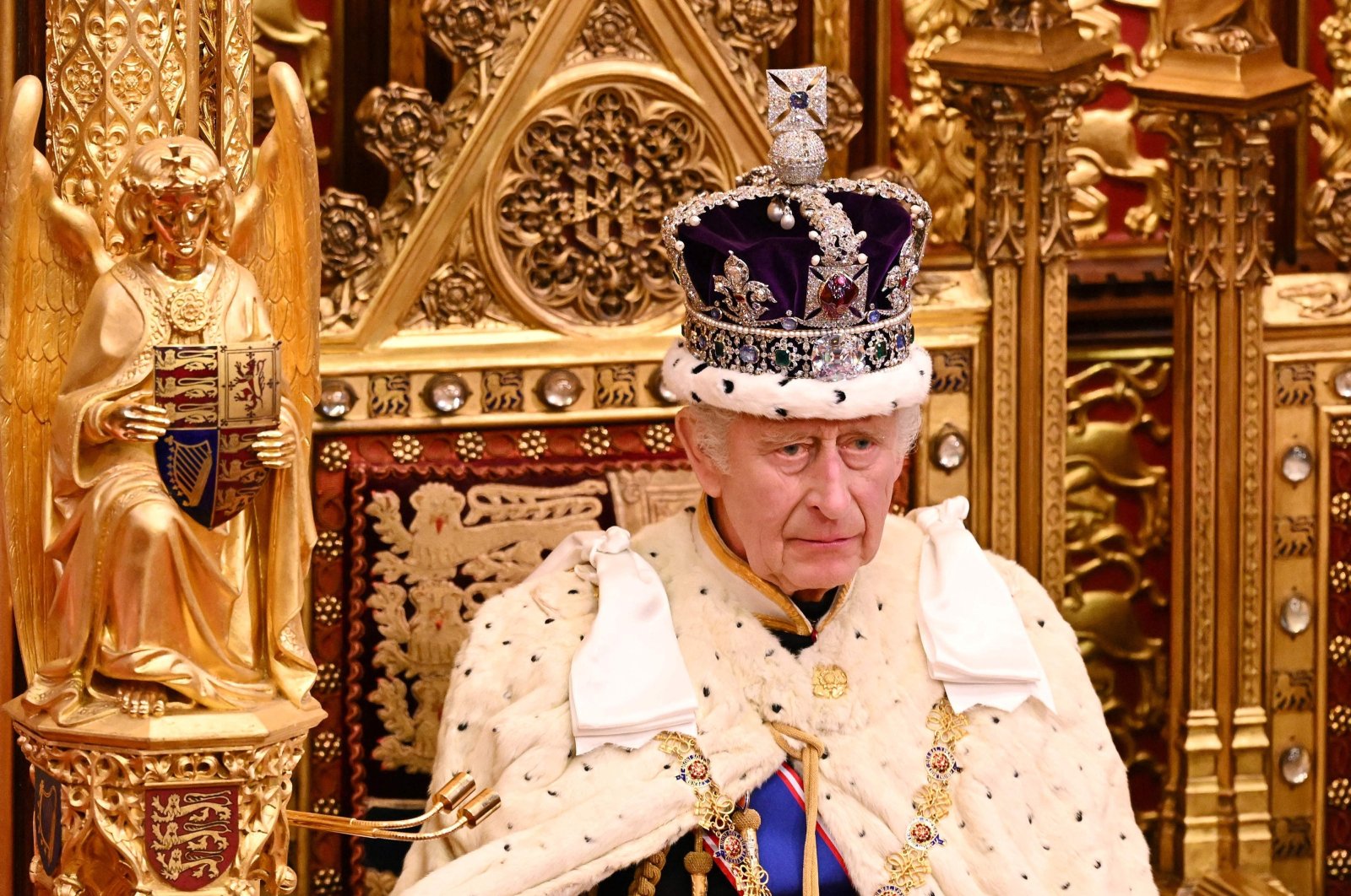 Britain&#039;s King Charles III, wearing the Imperial State Crown and the Robe of State, sits on The Sovereign&#039;s Throne in the House of Lords chamber, during the State Opening of Parliament, at the Houses of Parliament, in London, on Nov. 7, 2023. (AFP Photo)