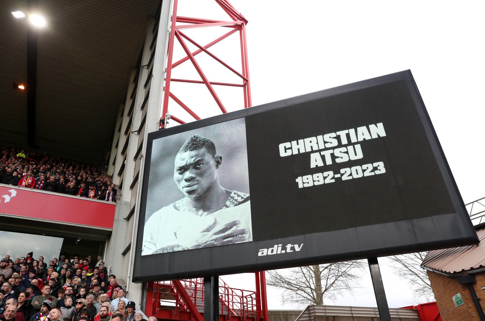 An image of Christian Atsu, who was recovered from the rubble of his home in Hatay following the Türkiye earthquake, is shown on the screen as a minute&#039;s silence is observed in his memory prior to the Premier League match between Nottingham Forest and Manchester City at City Ground, Nottingham, U.K., Feb. 18, 2023. (Getty Images Photo)