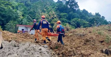 A handout photo provided by the Bureau of Fire Protection (BFP) shows rescuers working as they continue a search operation at a landslide-hit village in the town of Maco, Davao de Oro province, Philippines, Feb. 7, 2024. (EPA Photo)