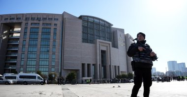 A police officer stands guard outside the courthouse after the attack, in Istanbul, Türkiye, Feb. 6, 2024. (IHA Photo)